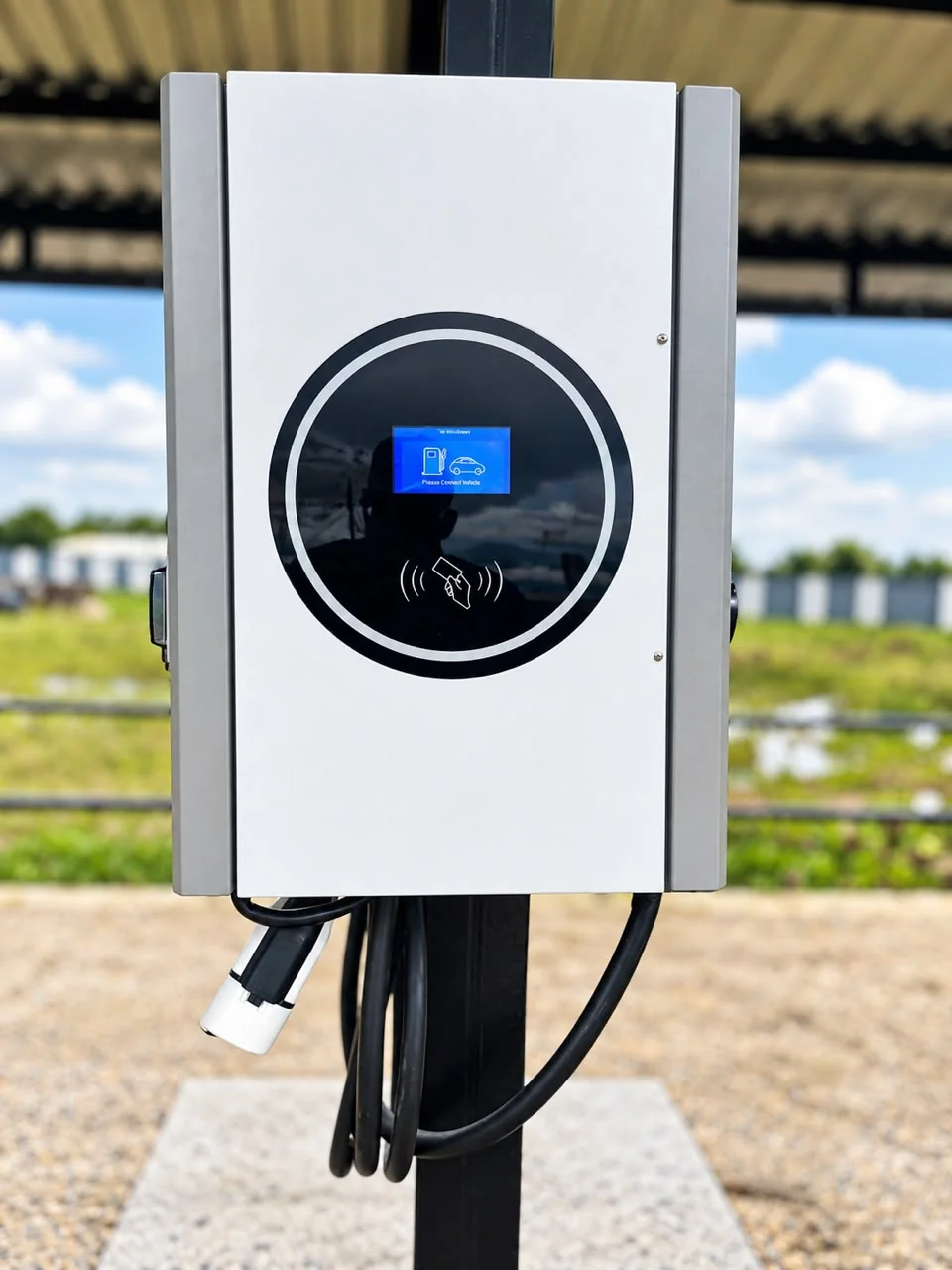Close-up of a pole-mounted AC charger with its screen and card reader