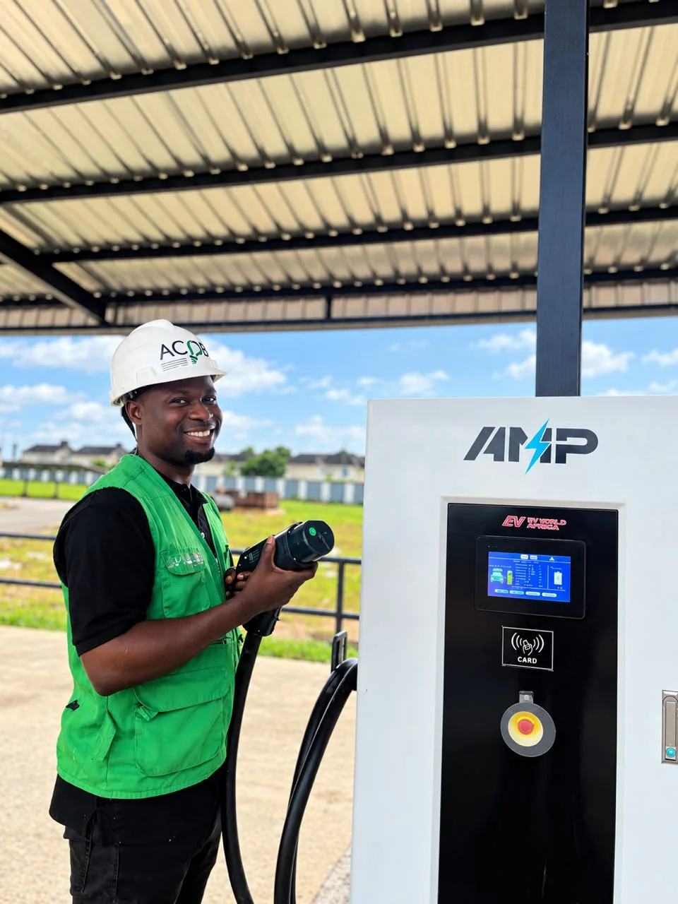 An ACOB engineer holding the connector of a DC fast charger
